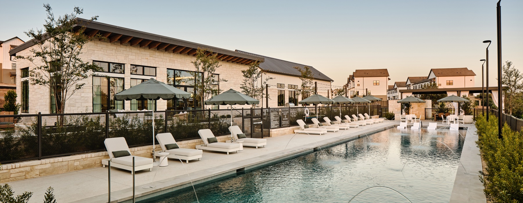 Pool with chairs and building 